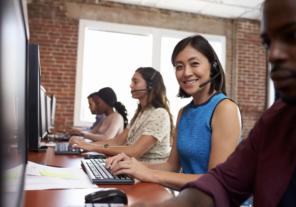Customer service team wearing headsets in an office