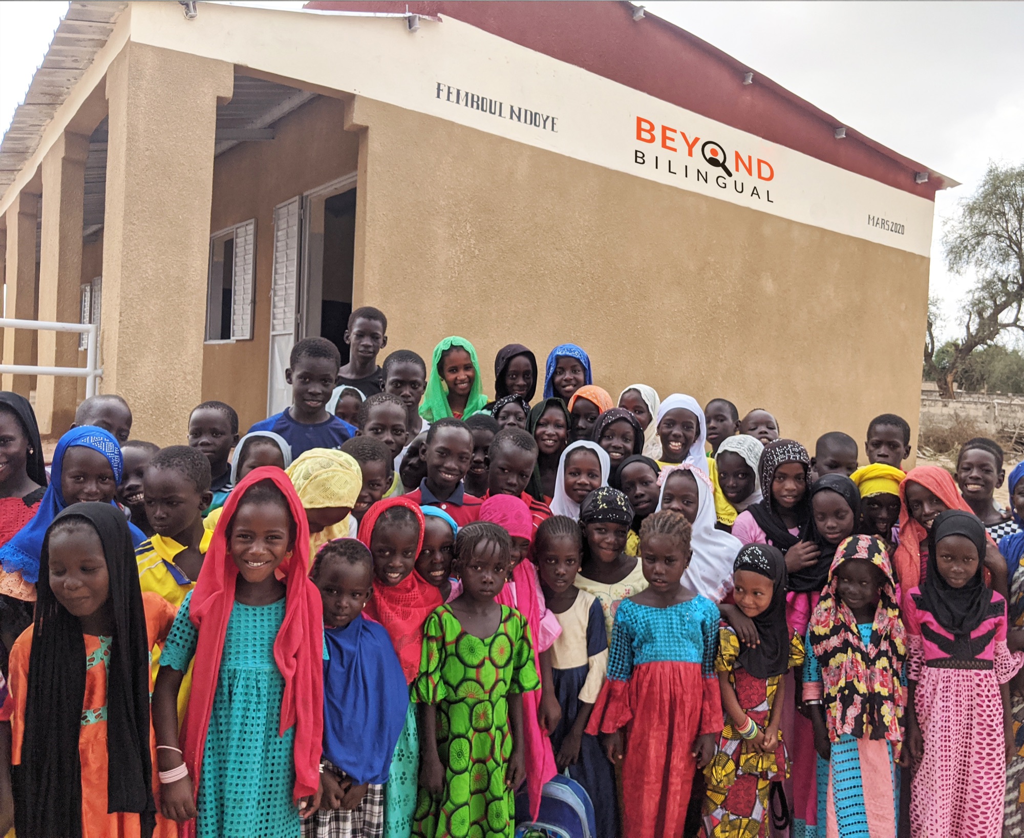 Students gathered outside the completed Beyond Bilingual school in Femboul Ndoye, Senegal